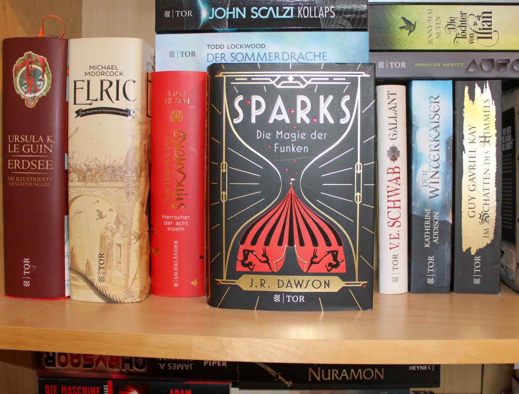 Hardcover-Ausgabe des Buchs "Sparks - Die Magie der Funken" mit dem Titelbild nach vorne in einem Bücherregal stehend.
